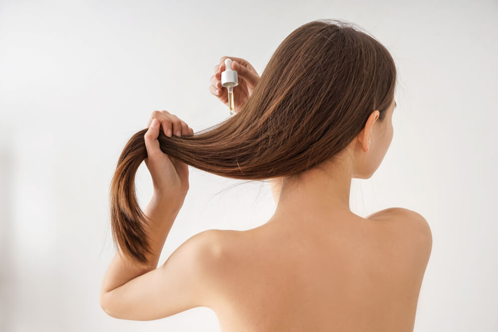 Woman using hair serum