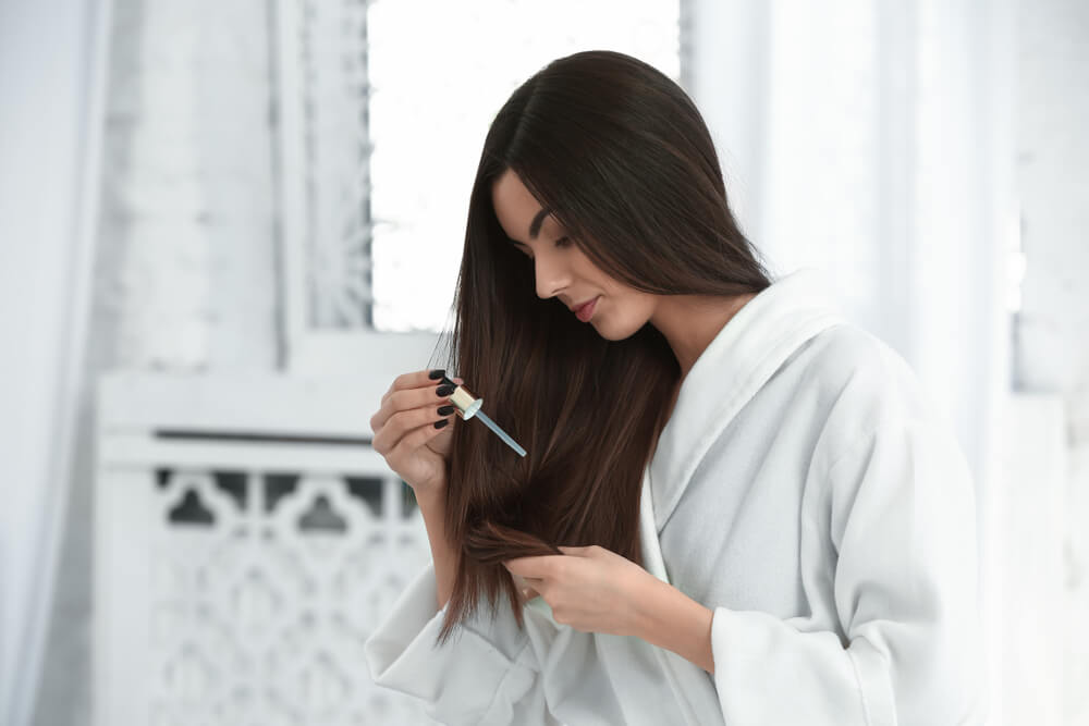 Woman using hair serum