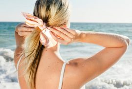 Woman doing hair on beach