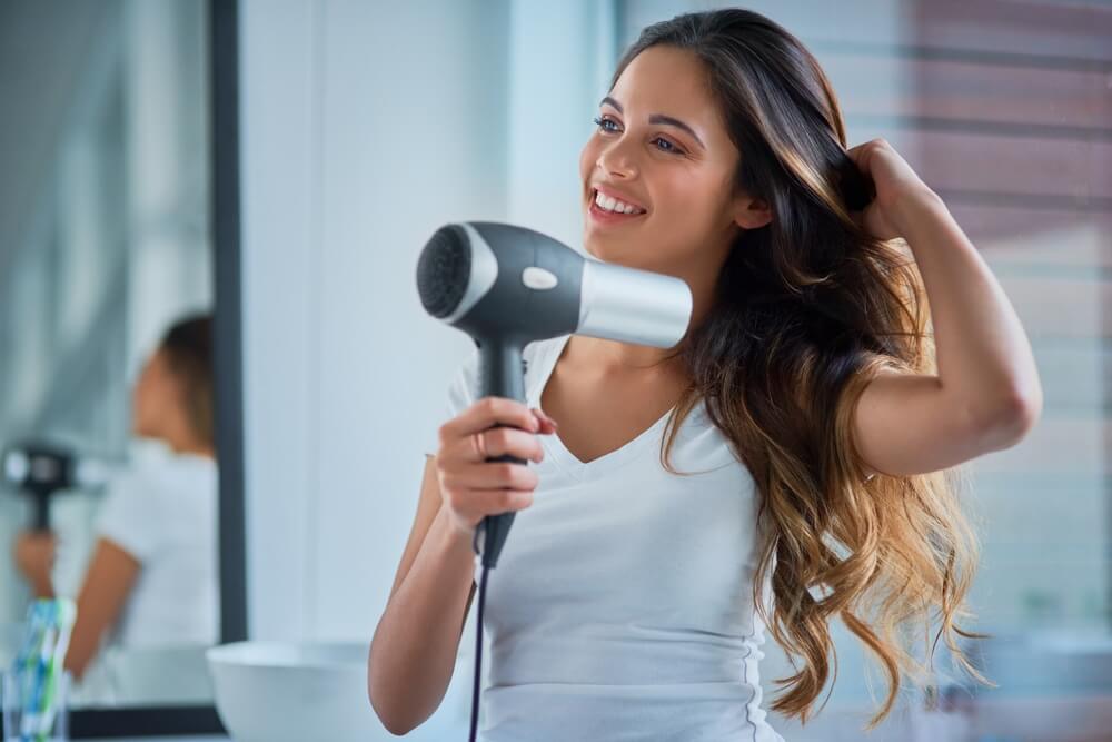 Woman blow drying hair