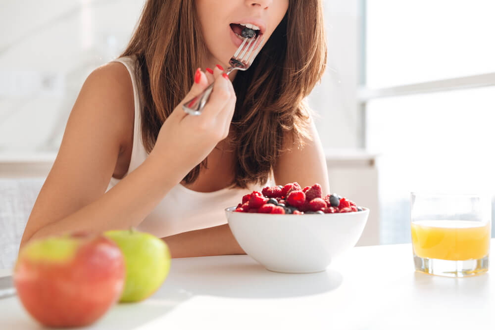 Woman eating fruits - diet for healthy hair