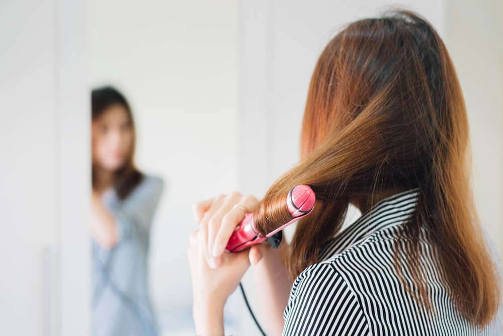 Woman curling hair