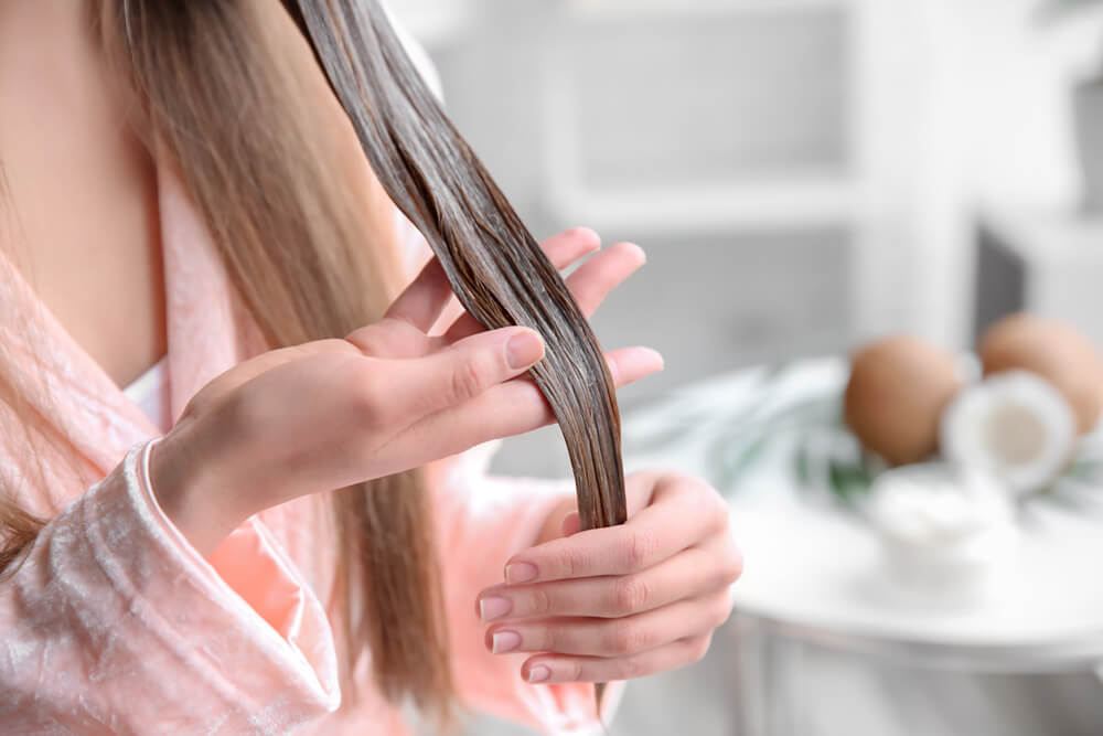 Hair mask on ends of woman's hair