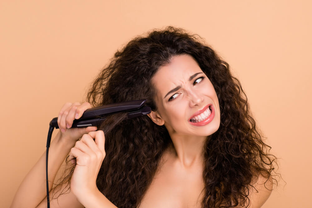 woman with hair straightener