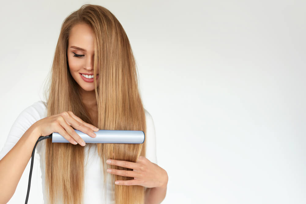 woman straightening her hair