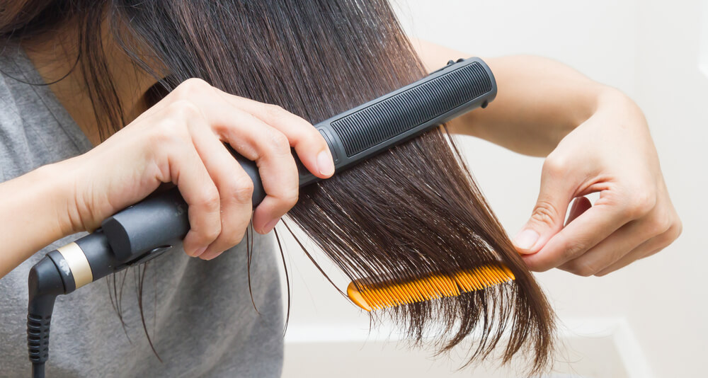 girl using straightener