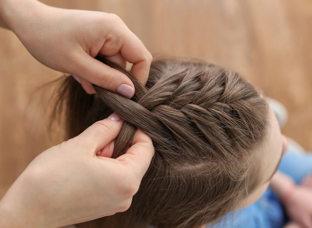 girl having hair braided