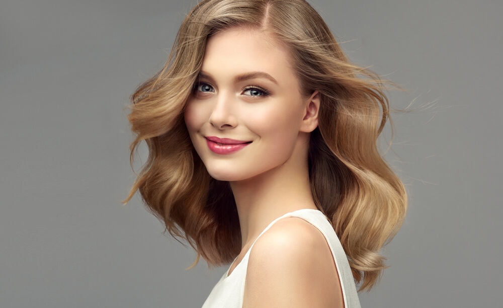 woman with wavy hair smiling